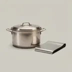 Used stainless-steel scrap: a cooking pot and lid beside a folded sheet offcut.